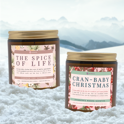 Two candles with decorative labels on a snowy background