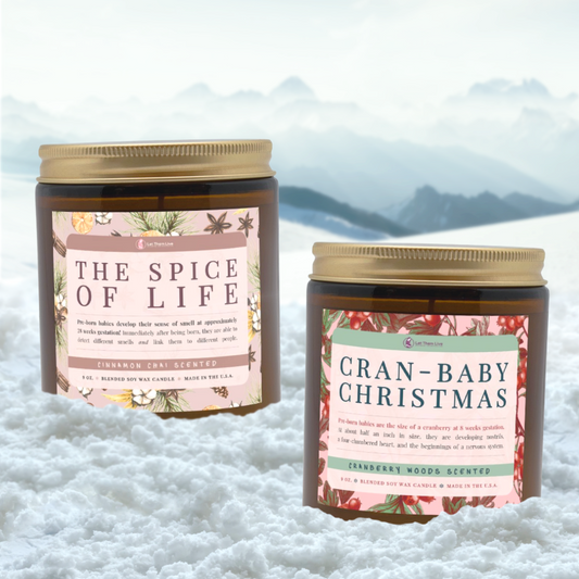 Two candles with decorative labels on a snowy background