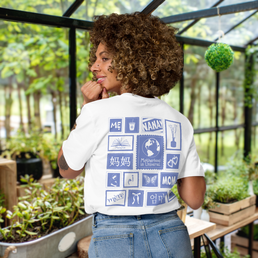 Woman in greenhouse wearing white shirt with blue stamps